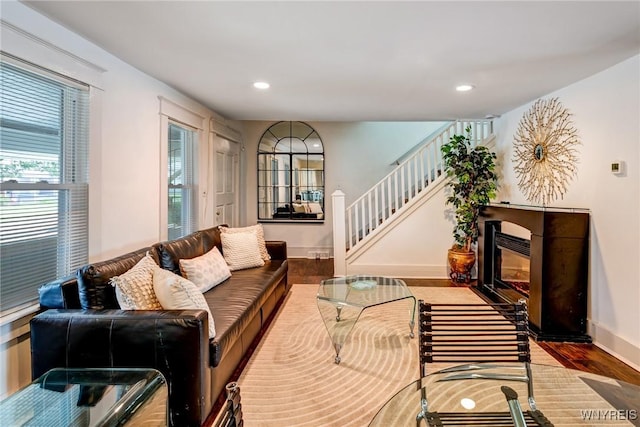 1143 Kensington Ave, Buffalo, NY 14215 - living area with wood finished floors, recessed lighting, stairway, and a glass covered fireplace