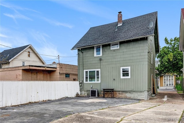 1143 Kensington Ave, Buffalo, NY 14215 - rear view of house with roof with shingles and a chimney