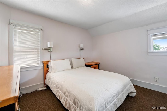 1143 Kensington Ave, Buffalo, NY 14215 - bedroom featuring dark carpet and lofted ceiling