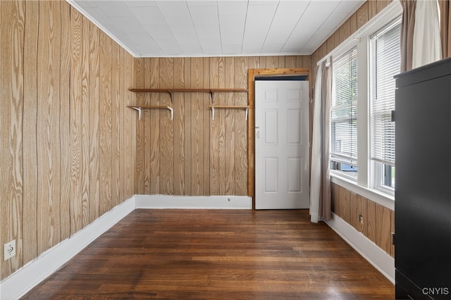 345 Wayland Rd, Salina, NY 13208 - unfurnished room featuring wood walls, healthy amount of natural light, and dark wood-style flooring