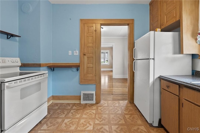 345 Wayland Rd, Salina, NY 13208 - kitchen with white appliances, dark countertops, and crown molding