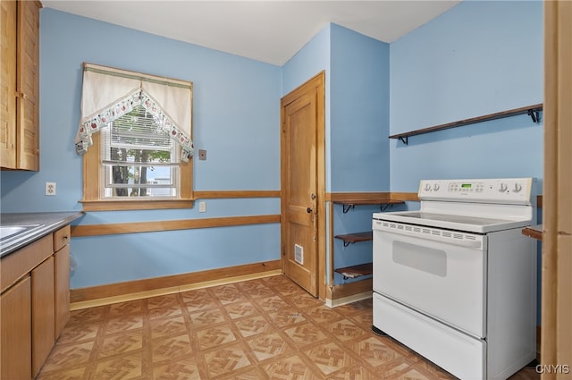 345 Wayland Rd, Salina, NY 13208 - kitchen with white range with electric stovetop and light floors