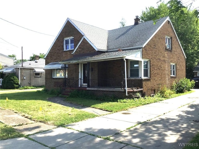 25 Fernwood Ave, West Seneca, NY 14206 - view of front of house with a front yard, a porch, brick siding, a chimney, and roof with shingles