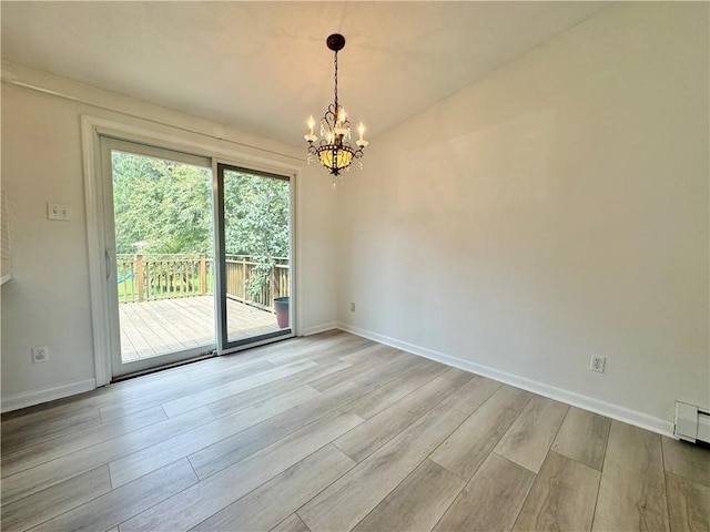 12017 Birch Dr, Corning, NY 14830 - spare room with a chandelier and light wood finished floors