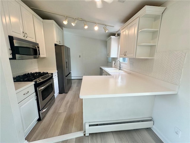12017 Birch Dr, Corning, NY 14830 - kitchen with appliances with stainless steel finishes, light wood-style floors, a peninsula, and white cabinets