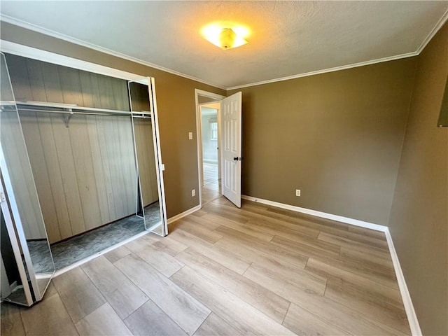 12017 Birch Dr, Corning, NY 14830 - unfurnished bedroom with wood finished floors, ornamental molding, a closet, and a textured ceiling