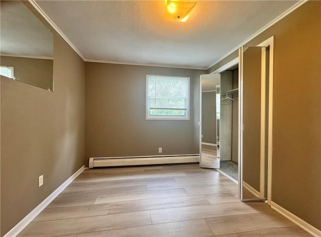 12017 Birch Dr, Corning, NY 14830 - unfurnished bedroom featuring baseboard heating, ornamental molding, wood finished floors, and a closet