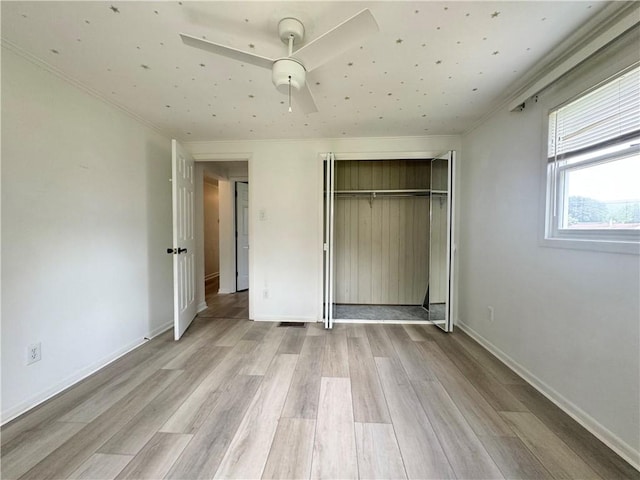 12017 Birch Dr, Corning, NY 14830 - unfurnished bedroom with light wood finished floors, a closet, a ceiling fan, and crown molding