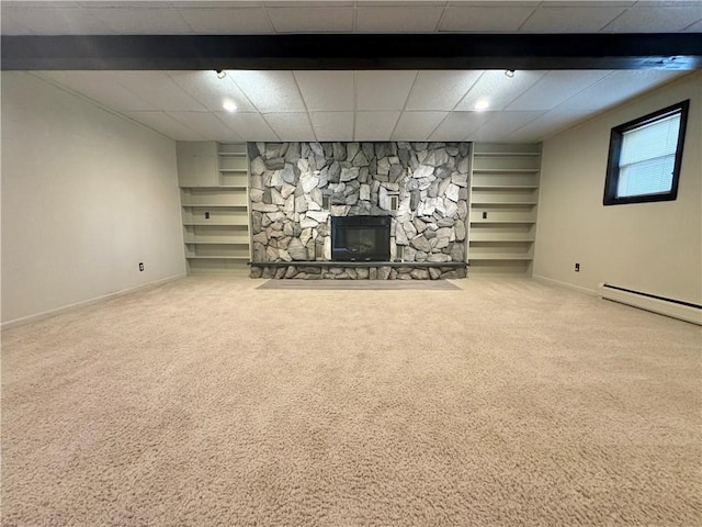 12017 Birch Dr, Corning, NY 14830 - basement featuring carpet, a stone fireplace, a baseboard heating unit, and built in shelves