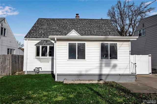40 Remington Pl, Buffalo, NY 14210 - rear view of house with a chimney, roof with shingles, and a patio