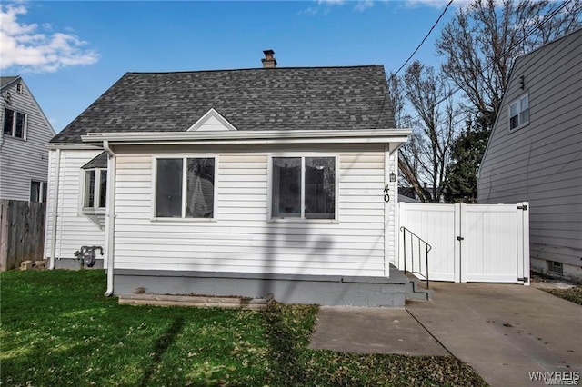 40 Remington Pl, Buffalo, NY 14210 - view of home's exterior featuring a gate, a patio, a chimney, and a shingled roof