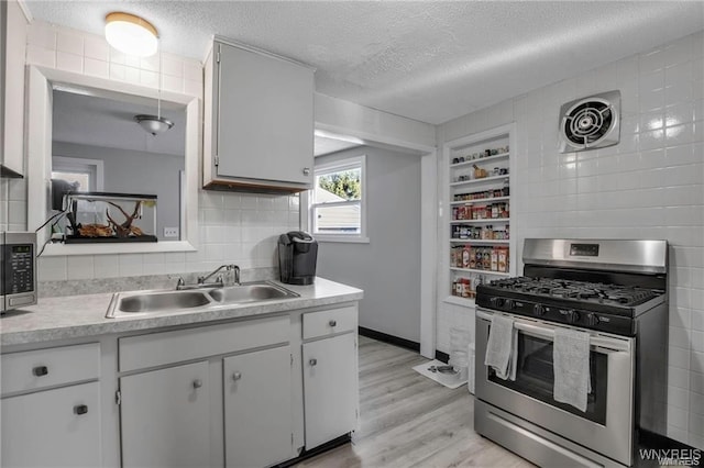 40 Remington Pl, Buffalo, NY 14210 - kitchen featuring appliances with stainless steel finishes, a textured ceiling, light countertops, light wood finished floors, and white cabinets