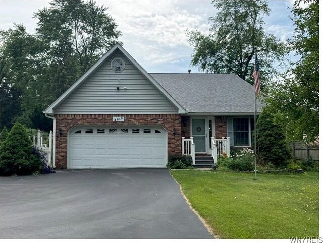 4610 Harris Hill Rd, Clarence, NY 14221 - single story home featuring asphalt driveway, a garage, a front yard, and brick siding