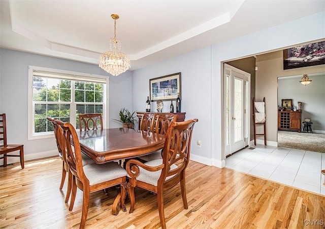 7991 Austrian Pine Cir, Pompey, NY 13104 - dining room featuring a tray ceiling, a chandelier, and light wood-style floors
