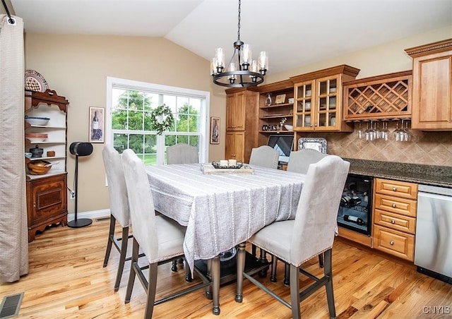 7991 Austrian Pine Cir, Pompey, NY 13104 - dining room featuring a chandelier, light wood-style flooring, lofted ceiling, wine cooler, and a dry bar