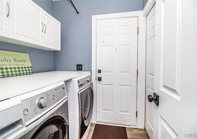 7991 Austrian Pine Cir, Pompey, NY 13104 - laundry area featuring cabinet space, washer and clothes dryer, and wood finished floors