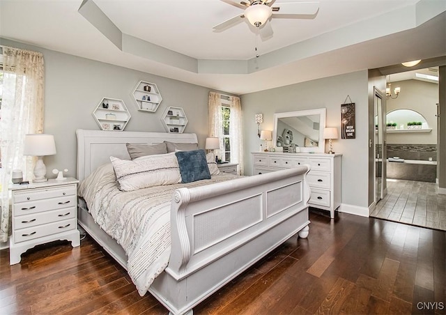 7991 Austrian Pine Cir, Pompey, NY 13104 - bedroom featuring dark wood finished floors, a raised ceiling, a chandelier, ensuite bathroom, and a ceiling fan