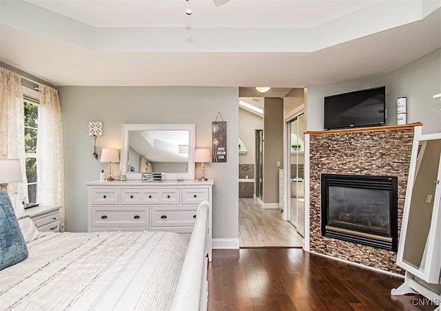 7991 Austrian Pine Cir, Pompey, NY 13104 - bedroom with dark wood-style flooring, a fireplace, and a raised ceiling