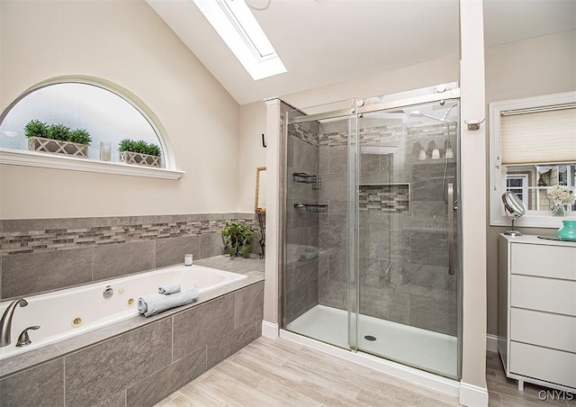 7991 Austrian Pine Cir, Pompey, NY 13104 - bathroom with a jetted tub, lofted ceiling, a skylight, a shower stall, and wood finished floors