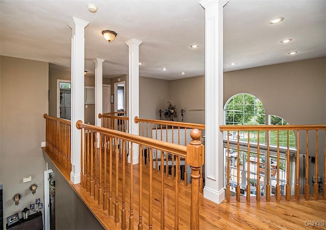 7991 Austrian Pine Cir, Pompey, NY 13104 - corridor featuring ornate columns, an upstairs landing, wood finished floors, and recessed lighting