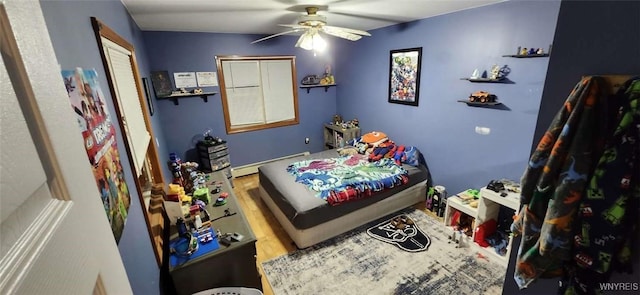 239 Bullis Rd, West Seneca, NY 14224 - bedroom featuring a baseboard radiator and a ceiling fan
