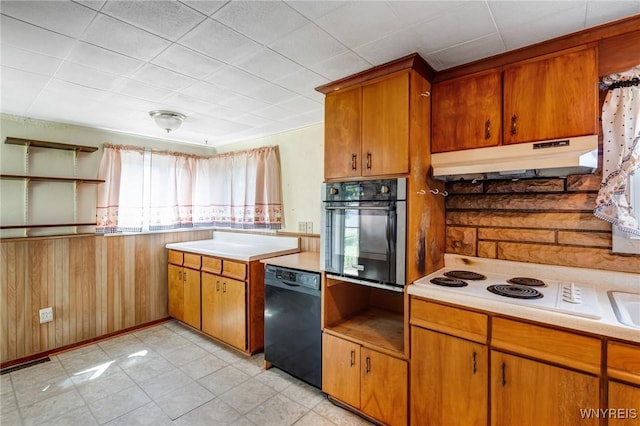 5910 Edgewood Dr, Niagara, NY 14304 - kitchen with black appliances, under cabinet range hood, light countertops, and brown cabinetry