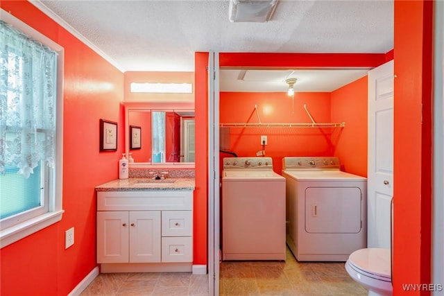 5910 Edgewood Dr, Niagara, NY 14304 - laundry room featuring washing machine and dryer, healthy amount of natural light, and a textured ceiling
