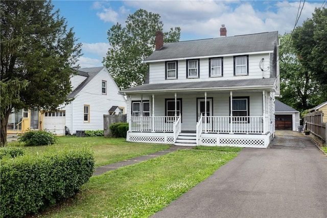 1995 Grand Central Ave, Horseheads, NY 14845 - view of front of house featuring covered porch, an outdoor structure, a garage, and a chimney
