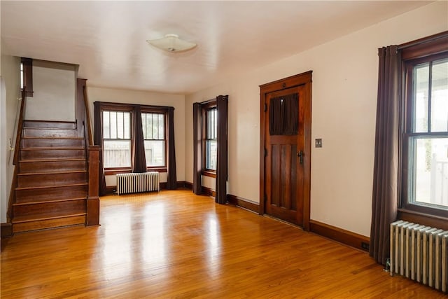 1995 Grand Central Ave, Horseheads, NY 14845 - foyer entrance featuring radiator heating unit, light wood-style flooring, and stairway