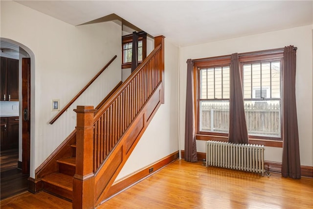 1995 Grand Central Ave, Horseheads, NY 14845 - stairs featuring radiator heating unit, wood finished floors, and arched walkways