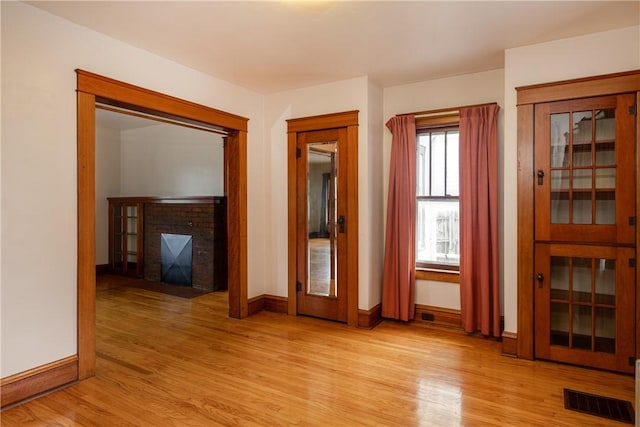 1995 Grand Central Ave, Horseheads, NY 14845 - empty room featuring a fireplace and light wood-style floors