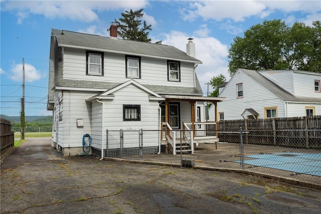 1995 Grand Central Ave, Horseheads, NY 14845 - back of property featuring a chimney, a gate, covered porch, and roof with shingles