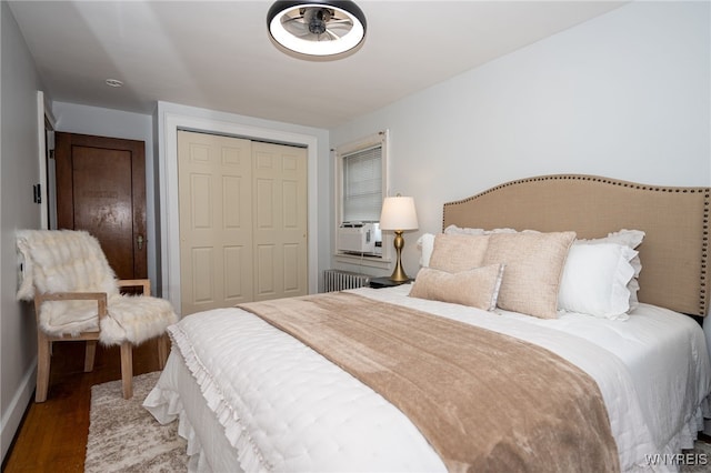 2912 Eggert Rd, Tonawanda, NY 14150 - bedroom with radiator, a closet, wood finished floors, and cooling unit