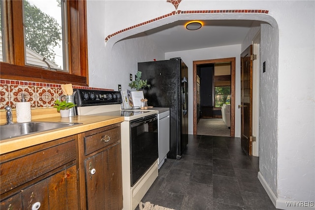 2912 Eggert Rd, Tonawanda, NY 14150 - kitchen with electric stove, a textured wall, backsplash, and light countertops