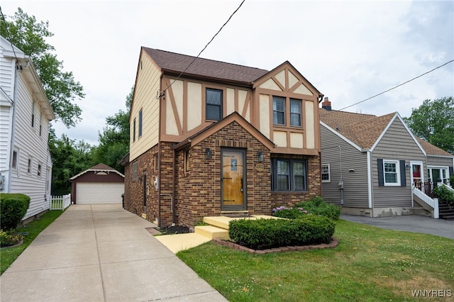 2912 Eggert Rd, Tonawanda, NY 14150 - tudor home with stucco siding, brick siding, a garage, and an outbuilding