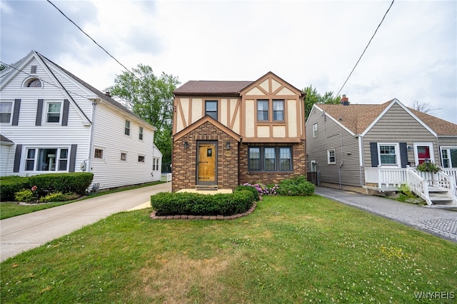 2912 Eggert Rd, Tonawanda, NY 14150 - english style home featuring stucco siding, brick siding, and a front yard