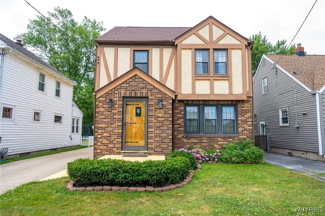2912 Eggert Rd, Tonawanda, NY 14150 - tudor home featuring brick siding, stucco siding, and a front lawn