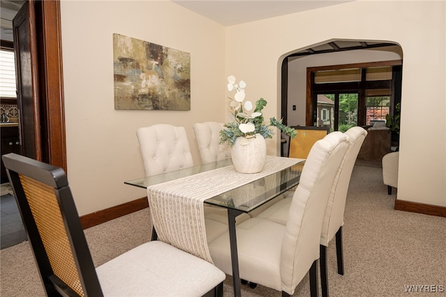 2912 Eggert Rd, Tonawanda, NY 14150 - carpeted dining space featuring arched walkways and baseboards