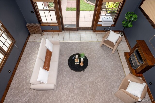 2912 Eggert Rd, Tonawanda, NY 14150 - carpeted living room with radiator and tile patterned flooring