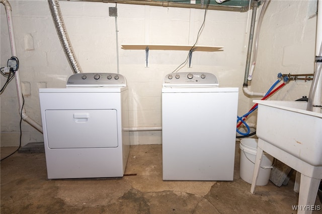 2912 Eggert Rd, Tonawanda, NY 14150 - laundry room with separate washer and dryer and concrete block wall
