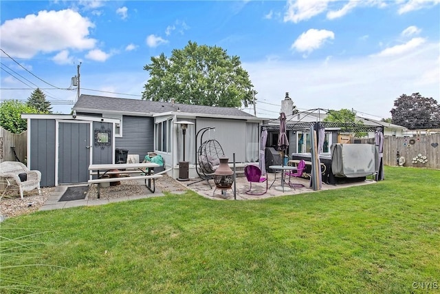 511 Drexler St, Salina, NY 13088 - rear view of property featuring a gazebo, a fenced backyard, a patio, an outbuilding, and a chimney