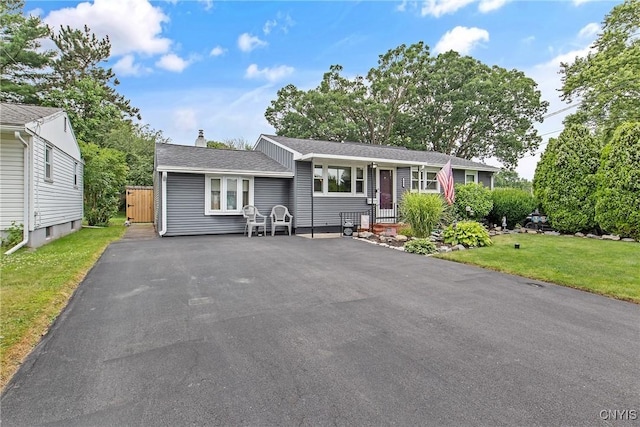 511 Drexler St, Salina, NY 13088 - view of front of house featuring driveway, a front lawn, a chimney, and roof with shingles