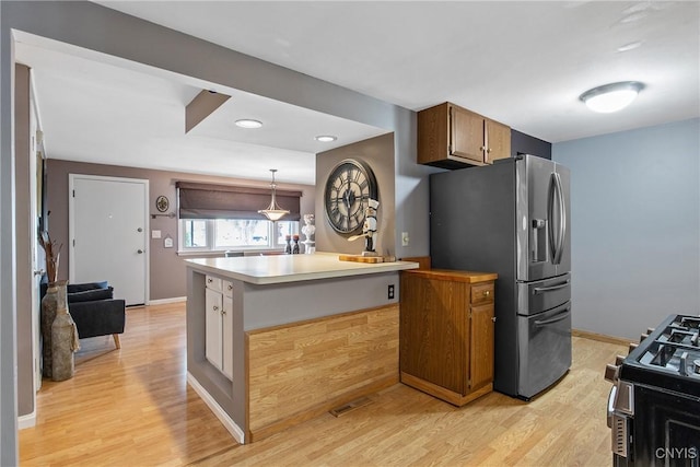 511 Drexler St, Salina, NY 13088 - kitchen with stainless steel appliances, light wood-style floors, light countertops, brown cabinetry, and recessed lighting
