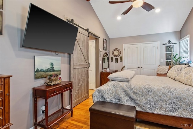 511 Drexler St, Salina, NY 13088 - bedroom with a barn door, lofted ceiling, light wood-type flooring, a closet, and a ceiling fan