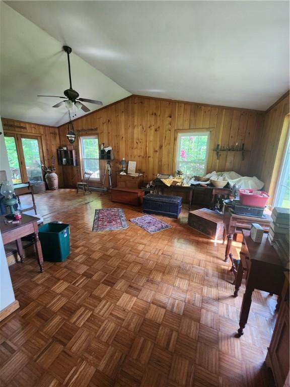 142 John Smith Rd, Pharsalia, NY 13844 - living area featuring vaulted ceiling, wood walls, and ceiling fan