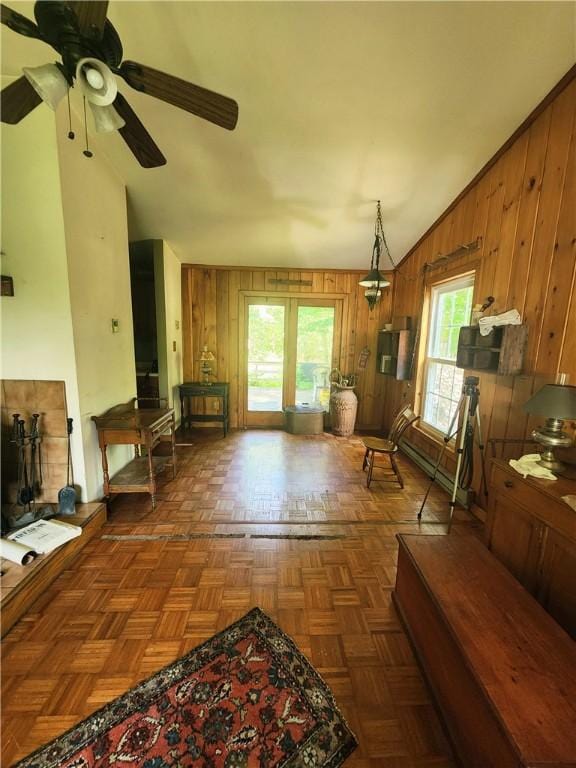 142 John Smith Rd, Pharsalia, NY 13844 - living room featuring wooden walls, healthy amount of natural light, and a ceiling fan