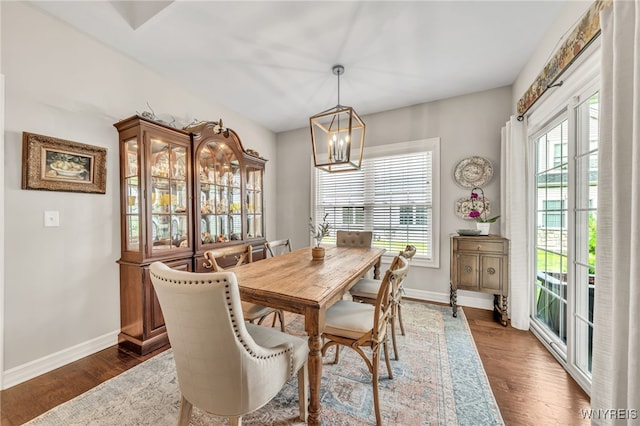 9443 Heritage Path Unit B, Clarence, NY 14032 - dining room with healthy amount of natural light, a chandelier, and dark wood finished floors