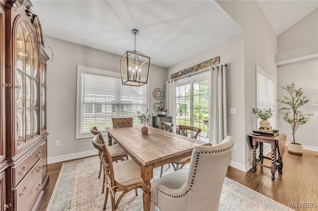 9443 Heritage Path Unit B, Clarence, NY 14032 - dining space featuring dark wood-type flooring, a chandelier, and vaulted ceiling