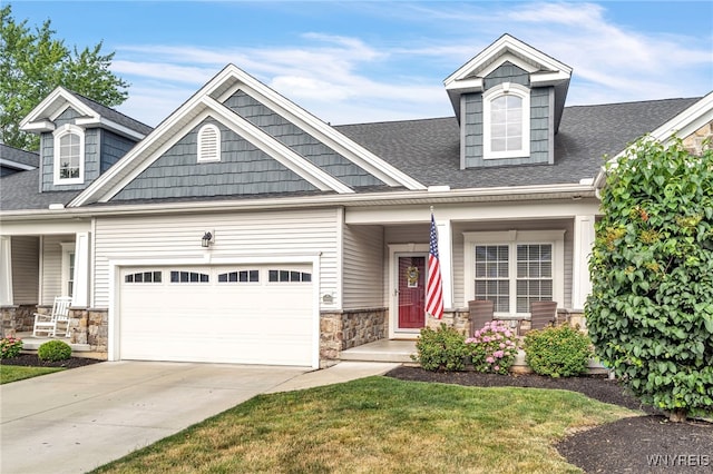 9443 Heritage Path Unit B, Clarence, NY 14032 - craftsman-style home with a porch, an attached garage, stone siding, roof with shingles, and concrete driveway