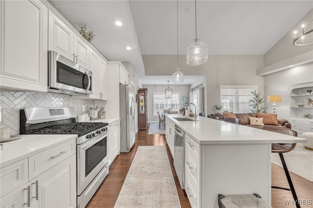 9443 Heritage Path Unit B, Clarence, NY 14032 - kitchen featuring stainless steel appliances, open floor plan, plenty of natural light, an island with sink, and recessed lighting